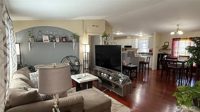 10426 11th Avenue Ct S, Tacoma, WA 98444 - living area with dark wood-style flooring, a chandelier, and vaulted ceiling
