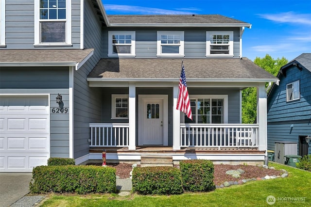 6209 Lincoln Dr, Ferndale, WA 98248 - view of front of house featuring covered porch, a shingled roof, and an attached garage