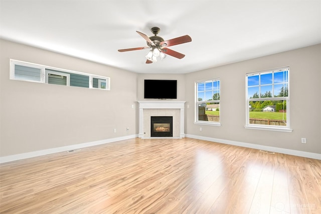 6209 Lincoln Dr, Ferndale, WA 98248 - unfurnished living room with light wood-type flooring, ceiling fan, and a tiled fireplace