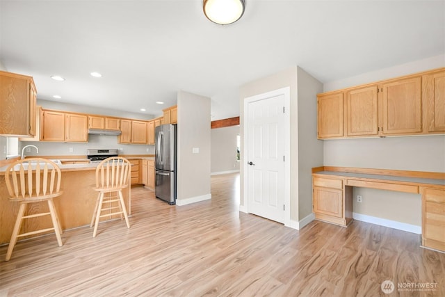 6209 Lincoln Dr, Ferndale, WA 98248 - kitchen featuring built in desk, light brown cabinetry, freestanding refrigerator, light wood finished floors, and light countertops