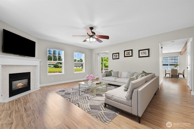 6209 Lincoln Dr, Ferndale, WA 98248 - living area featuring wood finished floors, a ceiling fan, healthy amount of natural light, and a tiled fireplace