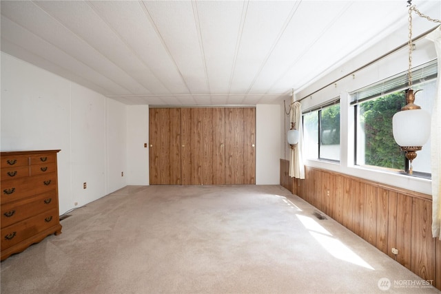 3611 I St NE Unit 10, Auburn, WA 98002 - spare room featuring wood walls and light colored carpet