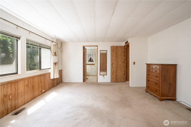 3611 I St NE Unit 10, Auburn, WA 98002 - unfurnished bedroom with wood walls, light carpet, and wainscoting