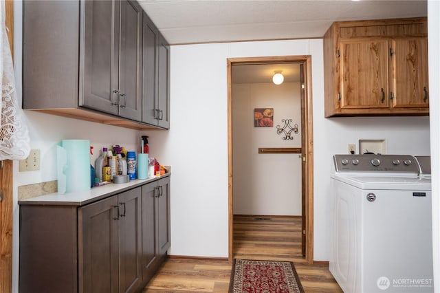 3611 I St NE Unit 10, Auburn, WA 98002 - laundry area with washer / dryer, light wood-style floors, and cabinet space