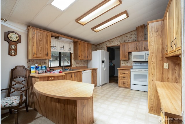 3611 I St NE Unit 10, Auburn, WA 98002 - kitchen with white appliances, vaulted ceiling, a peninsula, light floors, and tasteful backsplash