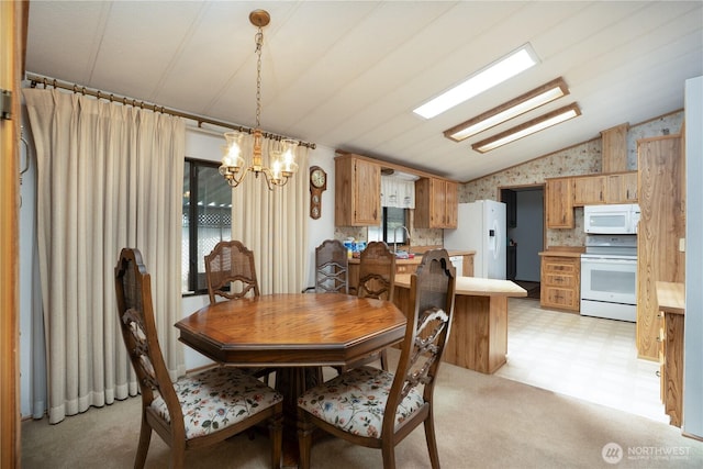 3611 I St NE Unit 10, Auburn, WA 98002 - dining room featuring lofted ceiling, a chandelier, healthy amount of natural light, wallpapered walls, and light floors