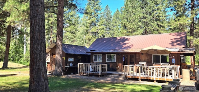 67 Northcott Rd, Winthrop, WA 98862 - rear view of house featuring a metal roof, a deck, and a yard