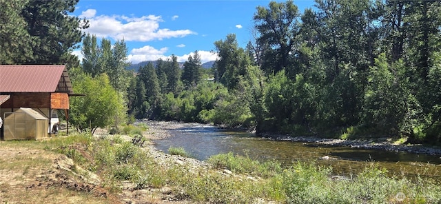 67 Northcott Rd, Winthrop, WA 98862 - water view featuring a greenhouse and a heavily wooded area