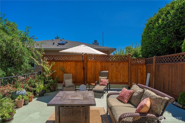1721 N Steele St, Tacoma, WA 98406 - fenced backyard featuring a patio area and an outdoor living space with a fire pit