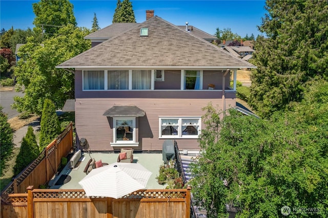1721 N Steele St, Tacoma, WA 98406 - rear view of property featuring roof with shingles, a fenced backyard, and a chimney