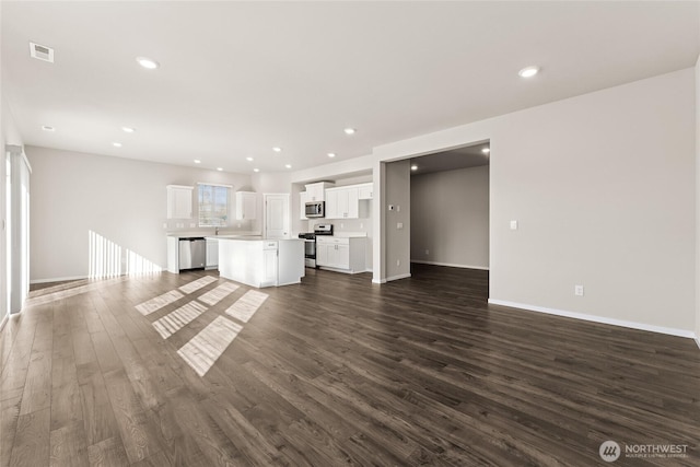 3913 23rd Ave NE Unit 97, Olympia, WA 98516 - unfurnished living room with dark wood-style floors and recessed lighting