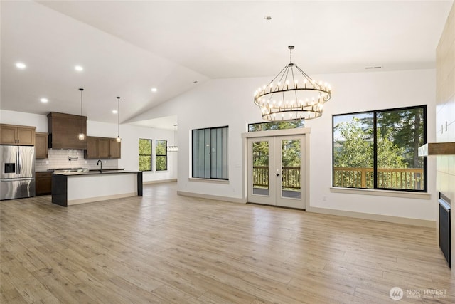 1450 Nelson Siding, Cle Elum, WA 98922 - unfurnished living room featuring a chandelier, light wood finished floors, high vaulted ceiling, and recessed lighting
