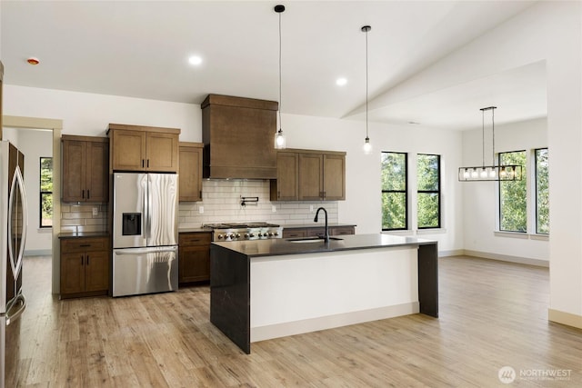 1450 Nelson Siding, Cle Elum, WA 98922 - kitchen with stainless steel refrigerator with ice dispenser, premium range hood, dark countertops, backsplash, and light wood-style flooring