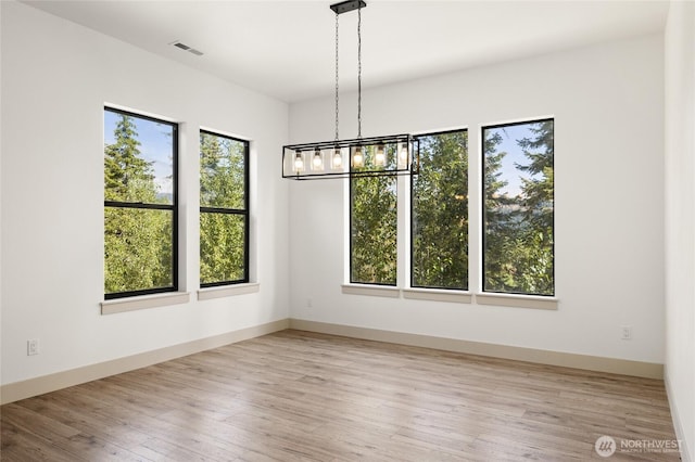 1450 Nelson Siding, Cle Elum, WA 98922 - unfurnished dining area with healthy amount of natural light, wood finished floors, and a chandelier