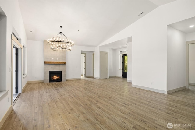 1450 Nelson Siding, Cle Elum, WA 98922 - unfurnished living room featuring lofted ceiling, light wood-type flooring, a chandelier, and a fireplace