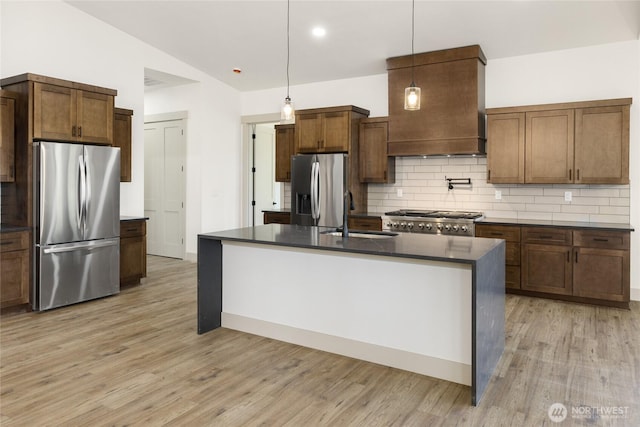 1450 Nelson Siding, Cle Elum, WA 98922 - kitchen featuring stainless steel fridge with ice dispenser, freestanding refrigerator, dark countertops, backsplash, and light wood-style floors
