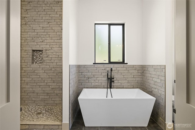 1450 Nelson Siding, Cle Elum, WA 98922 - bathroom featuring tile walls, a freestanding bath, wainscoting, tiled shower, and tile patterned flooring