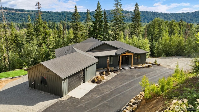 1450 Nelson Siding, Cle Elum, WA 98922 - view of front of property with a view of trees, board and batten siding, driveway, and an attached garage