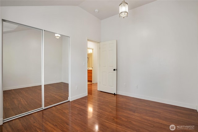 2025 Palisade Blvd, Dupont, WA 98327 - unfurnished bedroom with wood finished floors, a chandelier, a closet, and high vaulted ceiling