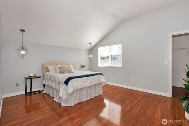 2025 Palisade Blvd, Dupont, WA 98327 - bedroom featuring vaulted ceiling, wood finished floors, and a spacious closet