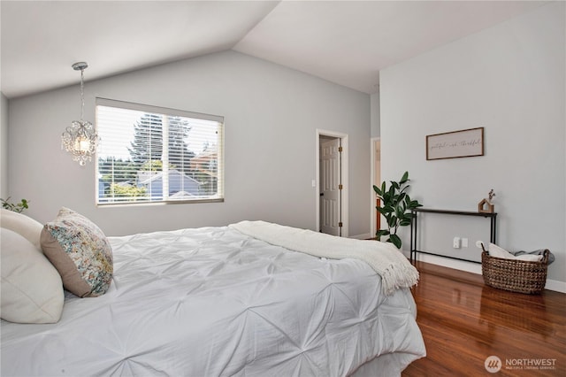 2025 Palisade Blvd, Dupont, WA 98327 - bedroom with wood finished floors, vaulted ceiling, and a chandelier