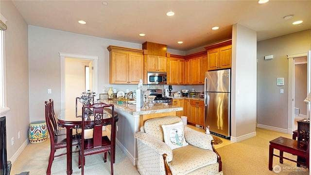 2837 E Lake Sammamish Pkwy NE, Sammamish, WA 98074 - kitchen with appliances with stainless steel finishes, light countertops, recessed lighting, light colored carpet, and a kitchen breakfast bar