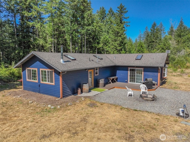 19002 Sorenson Rd SE, Yelm, WA 98597 - rear view of house with a patio, roof with shingles, and a lawn