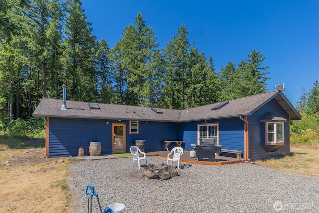 19002 Sorenson Rd SE, Yelm, WA 98597 - back of house with a fire pit and roof with shingles