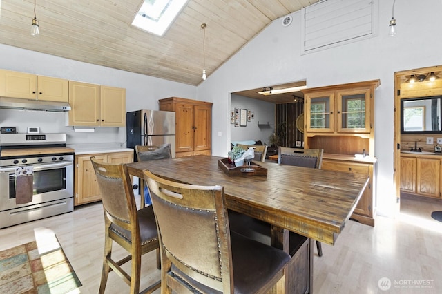 19002 Sorenson Rd SE, Yelm, WA 98597 - dining area featuring light wood finished floors, a skylight, high vaulted ceiling, and wooden ceiling
