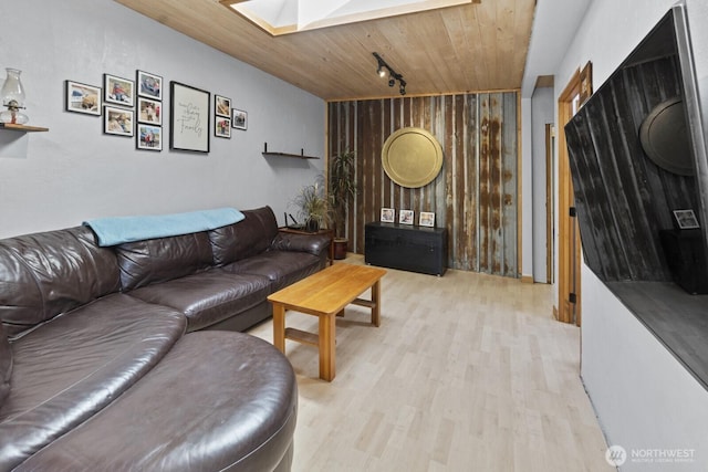 19002 Sorenson Rd SE, Yelm, WA 98597 - living area featuring light wood-style flooring, a skylight, wood walls, and wooden ceiling