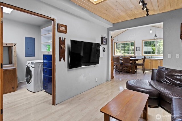 19002 Sorenson Rd SE, Yelm, WA 98597 - living room featuring washer / dryer, electric panel, rail lighting, light wood-style floors, and wood ceiling