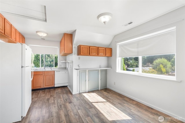 3711 116th St SE, Everett, WA 98208 - kitchen featuring white appliances, light countertops, wood finished floors, lofted ceiling, and brown cabinetry