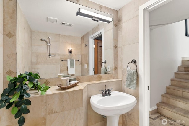 10036 NE 115th Ln Unit A3, Kirkland, WA 98033 - bathroom featuring tiled shower, tile walls, and tile patterned flooring