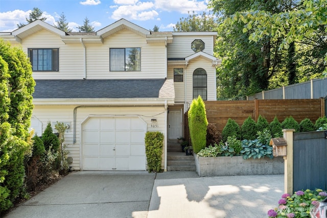 4051 S 159th Ln, Tukwila, WA 98188 - view of front facade featuring a garage, concrete driveway, and roof with shingles