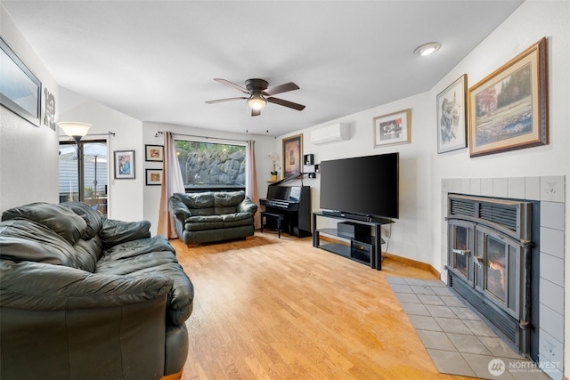 4051 S 159th Ln, Tukwila, WA 98188 - living area with light wood finished floors, a fireplace, ceiling fan, and a wall unit AC
