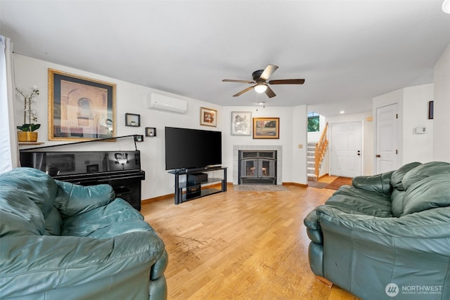 4051 S 159th Ln, Tukwila, WA 98188 - living area with ceiling fan, a fireplace, light wood-type flooring, stairway, and a wall unit AC