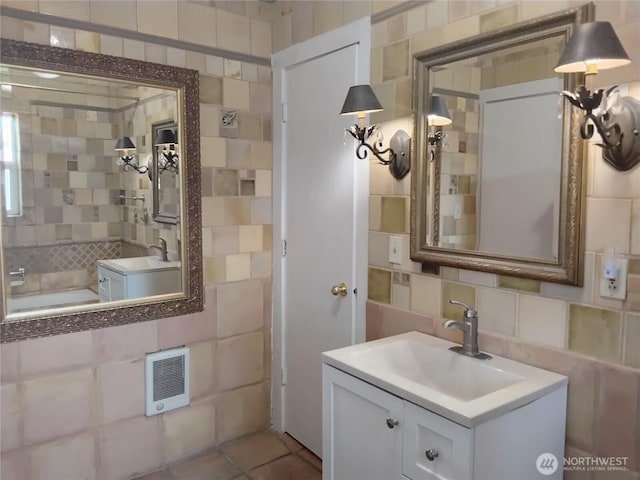306 Henderson Way E, Tonasket, WA 98855 - full bath with decorative backsplash, tile walls, vanity, and heating unit