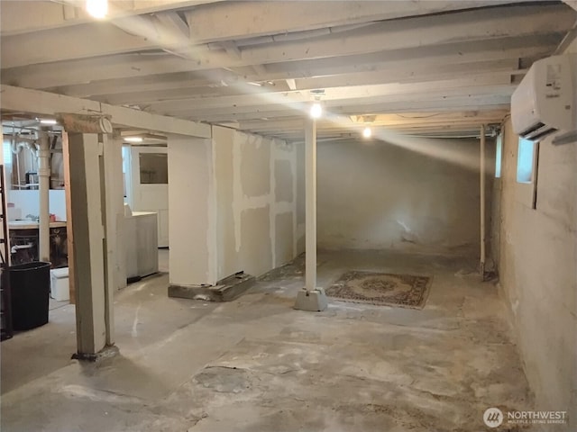 306 Henderson Way E, Tonasket, WA 98855 - below grade area featuring a wall mounted AC and washer / dryer