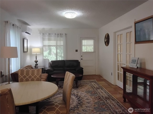 306 Henderson Way E, Tonasket, WA 98855 - living area with a wall mounted AC, tile patterned floors, and a textured ceiling