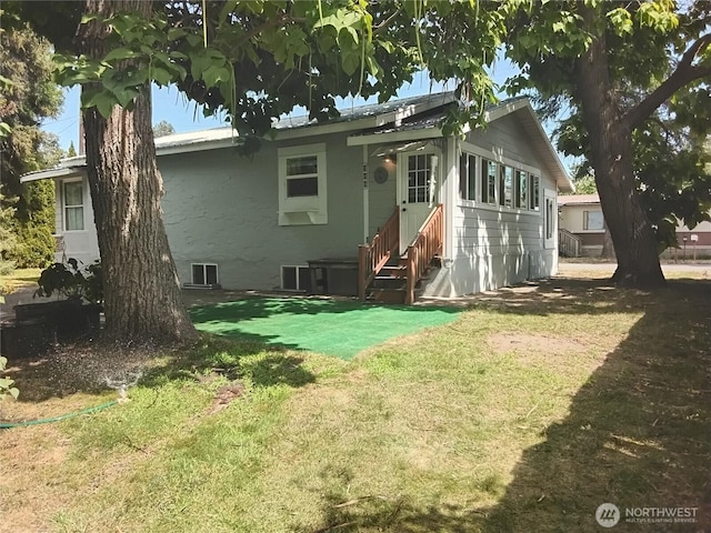 306 Henderson Way E, Tonasket, WA 98855 - back of property with a yard and entry steps
