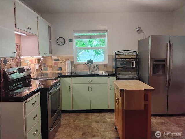 306 Henderson Way E, Tonasket, WA 98855 - kitchen with stainless steel appliances, decorative backsplash, butcher block counters, and green cabinets