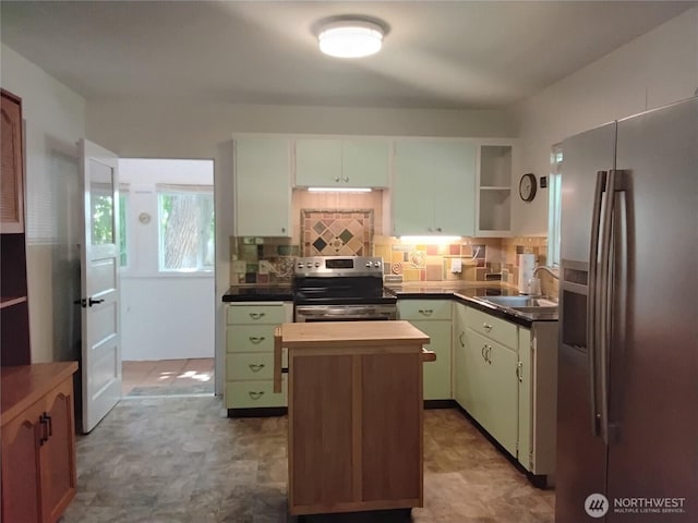 306 Henderson Way E, Tonasket, WA 98855 - kitchen with stainless steel appliances, open shelves, a center island, decorative backsplash, and tile patterned floors