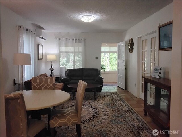 306 Henderson Way E, Tonasket, WA 98855 - tiled living area with a wall unit AC and a textured ceiling