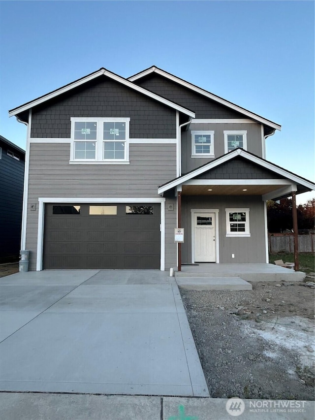 17851 26th Dr NE, Marysville, WA 98271 - view of front facade featuring an attached garage, concrete driveway, and a porch