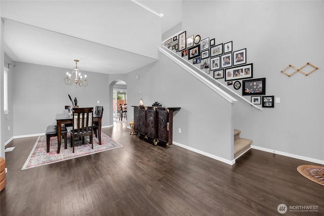6815 278th St NW, Stanwood, WA 98292 - dining space with arched walkways, stairs, wood finished floors, and a chandelier