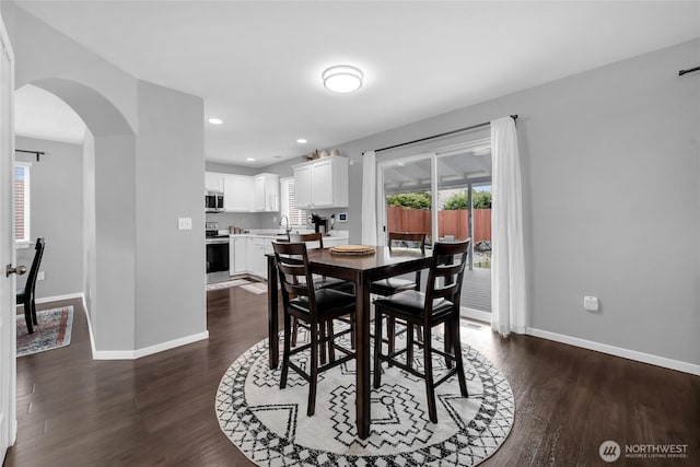6815 278th St NW, Stanwood, WA 98292 - dining area with arched walkways, dark wood-type flooring, plenty of natural light, and recessed lighting