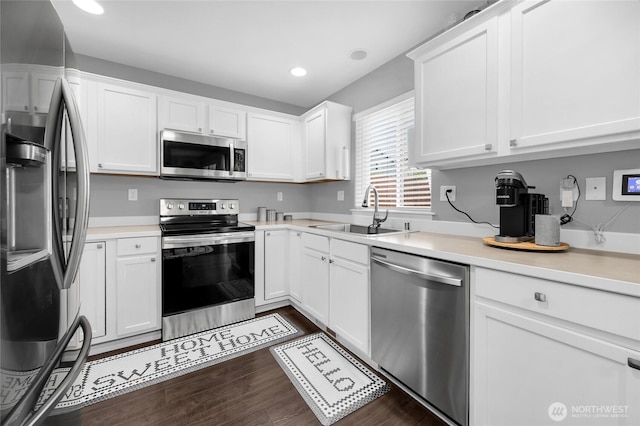 6815 278th St NW, Stanwood, WA 98292 - kitchen with appliances with stainless steel finishes, white cabinets, recessed lighting, light countertops, and dark wood finished floors