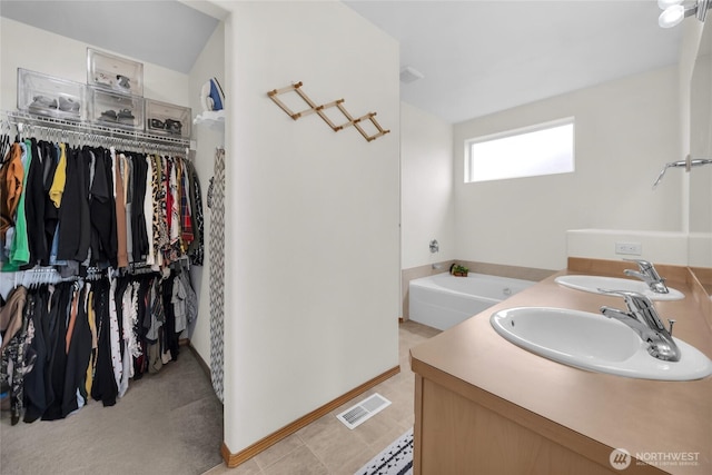 6815 278th St NW, Stanwood, WA 98292 - bathroom featuring double vanity, a bath, and a walk in closet