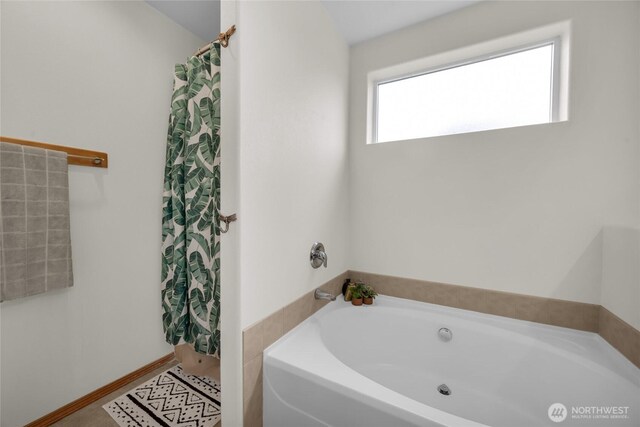6815 278th St NW, Stanwood, WA 98292 - bathroom featuring a garden tub and a shower with curtain