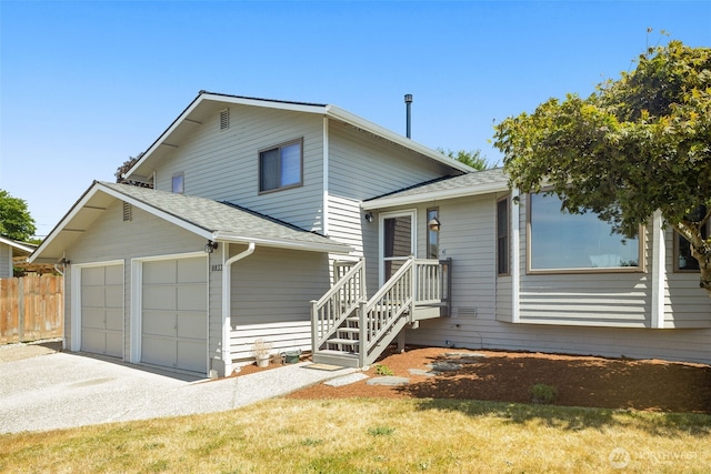 8833 47th Pl W, Mukilteo, WA 98275 - split level home featuring a shingled roof, an attached garage, and driveway
